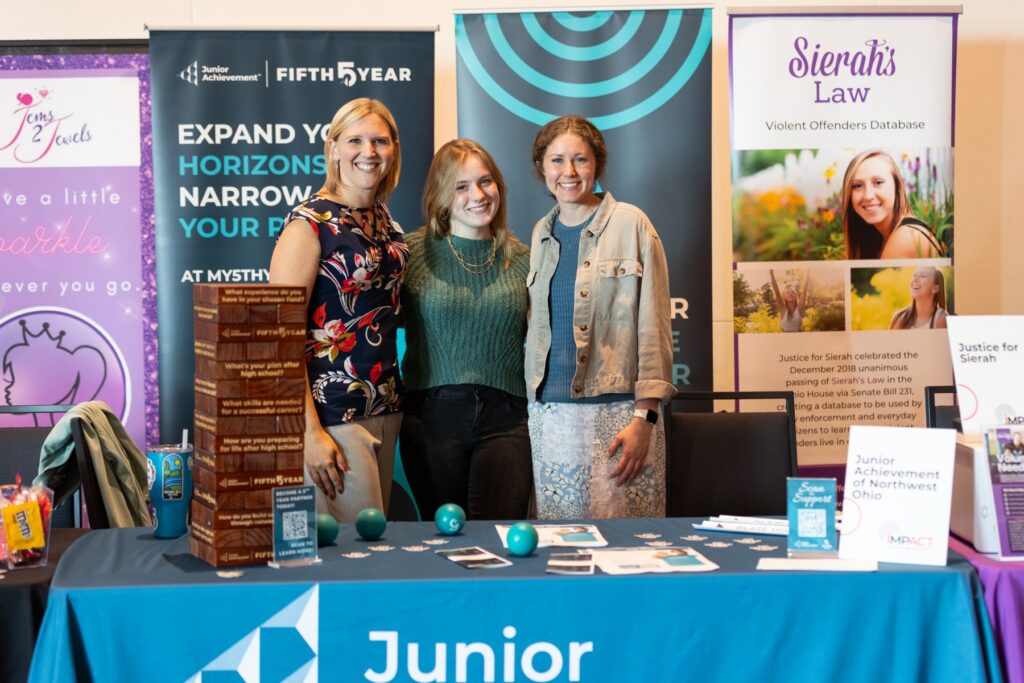 Three attendees at the Junior Achievement booth in the nonprofit showcase